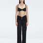 Front view of model wearing Angelique Black High-Rise Pants with layered panel and gold hoop accessory.
