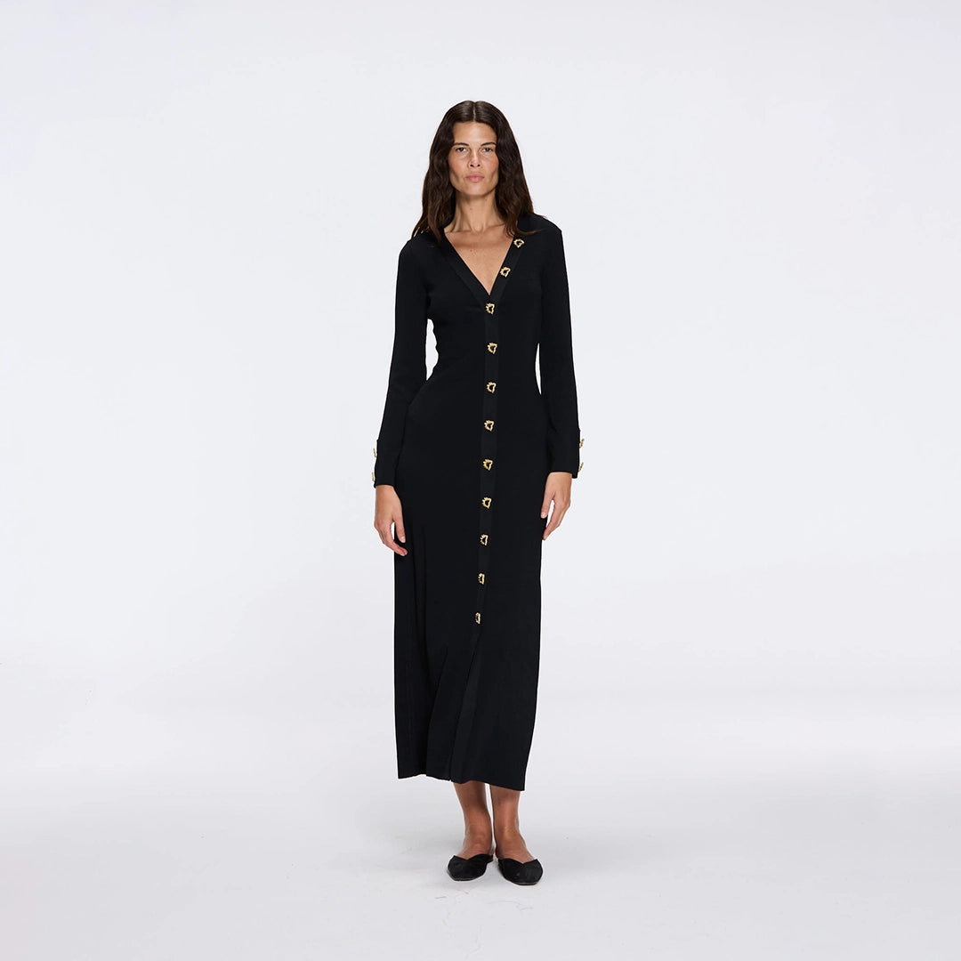 Brezia Black Knitted Maxi Dress with Long Sleeves and Gold Button Details | Moeva | RTW Dresses | Each week unveils new pieces—luxury swimwear, fluid resort silhouettes, and elevated summer-to-evening essentials designed to carry you from coastal escapes to city nights.