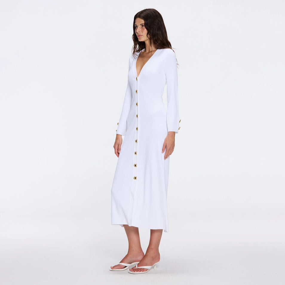 Brezia White Knitted Maxi Dress with Long Sleeves and Gold Button Details | Moeva | RTW Dresses | Each week unveils new pieces—luxury swimwear, fluid resort silhouettes, and elevated summer-to-evening essentials designed to carry you from coastal escapes to city nights.
