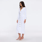 Brezia White Knitted Maxi Dress with Long Sleeves and Gold Button Details | Moeva | RTW Dresses | Each week unveils new pieces—luxury swimwear, fluid resort silhouettes, and elevated summer-to-evening essentials designed to carry you from coastal escapes to city nights.