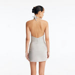 Clementine Silver Halterneck Swimsuit with Tie-Front Skirt Detail | Moeva | Swimsuit | Each week unveils new pieces—luxury swimwear, fluid resort silhouettes, and elevated summer-to-evening essentials designed to carry you from coastal escapes to city nights.