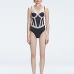 Front view of model wearing Camilla Black Optical Swimsuit with bandeau cut and boned torso for support.
