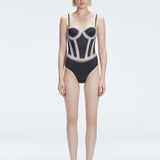 Front view of model wearing Camilla Black Optical Swimsuit with bandeau cut and boned torso for support.
