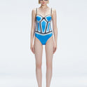 Front view of model wearing Camilla Blue Optical Swimsuit with bandeau cut and boned torso for support.
