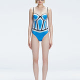 Front view of model wearing Camilla Blue Optical Swimsuit with bandeau cut and boned torso for support.
