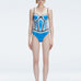 Front view of model wearing Camilla Blue Optical Swimsuit with bandeau cut and boned torso for support.
