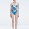 Front view of model wearing Camilla Blue Optical Swimsuit with bandeau cut and boned torso for support.
