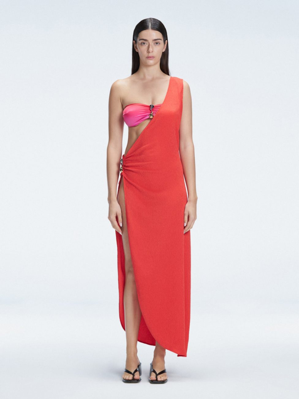 Front view of model wearing Coraline Red  Dress with chic one-shoulder design and trendy buckle detail.
