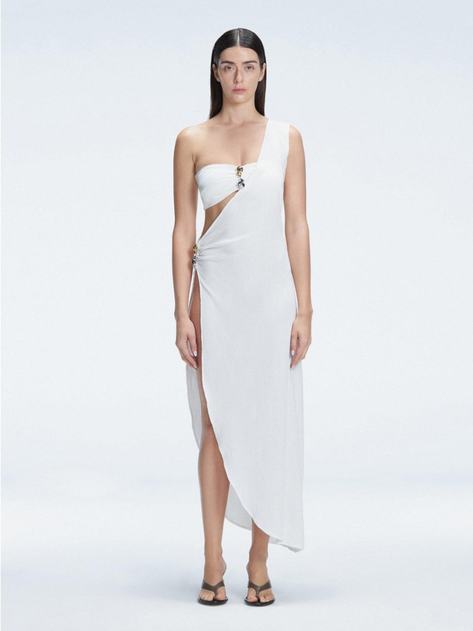 Front view of model wearing Coraline White Dress with chic one-shoulder design and trendy buckle detail.
