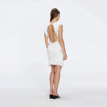 Diani White Fringe Detail Sheer Panel Open Back Mini Dress | Moeva | RTW Dresses | Each week unveils new pieces—luxury swimwear, fluid resort silhouettes, and elevated summer-to-evening essentials designed to carry you from coastal escapes to city nights.