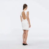 Diani White Fringe Detail Sheer Panel Open Back Mini Dress | Moeva | RTW Dresses | Each week unveils new pieces—luxury swimwear, fluid resort silhouettes, and elevated summer-to-evening essentials designed to carry you from coastal escapes to city nights.