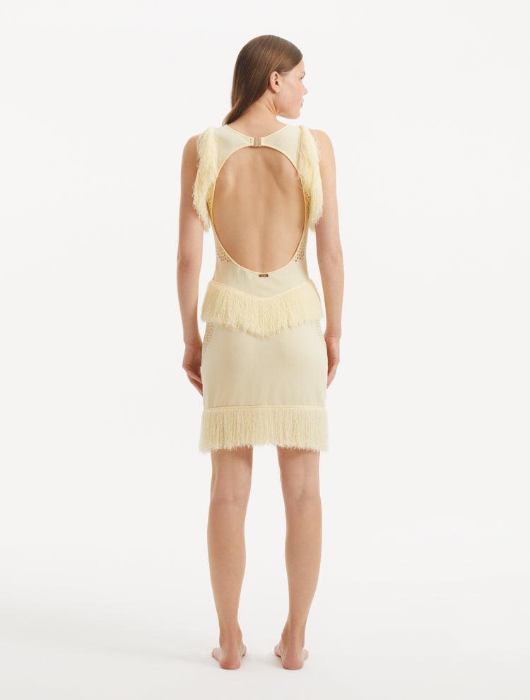 "Model wearing the Diani Yellow Dress from the back, showcasing the low back design with golden clasps."