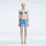 Evita Blue Optical Tie Side Sarong | Moeva | Sarong | Each week unveils new pieces—luxury swimwear, fluid resort silhouettes, and elevated summer-to-evening essentials designed to carry you from coastal escapes to city nights.
