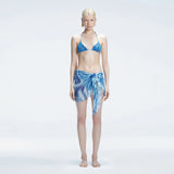 Evita Blue Optical Tie Side Sarong | Moeva | Sarong | Each week unveils new pieces—luxury swimwear, fluid resort silhouettes, and elevated summer-to-evening essentials designed to carry you from coastal escapes to city nights.
