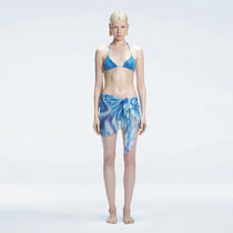 Evita Blue Optical Tie Side Sarong | Moeva | Sarong | Each week unveils new pieces—luxury swimwear, fluid resort silhouettes, and elevated summer-to-evening essentials designed to carry you from coastal escapes to city nights.