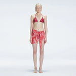 Evita Red Optical Tie Side Sarong | Moeva | Sarong | Each week unveils new pieces—luxury swimwear, fluid resort silhouettes, and elevated summer-to-evening essentials designed to carry you from coastal escapes to city nights.