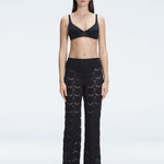 Front view of model wearing Elysia Black Wide-Leg Pants with low-rise fit and hidden side zipper.
