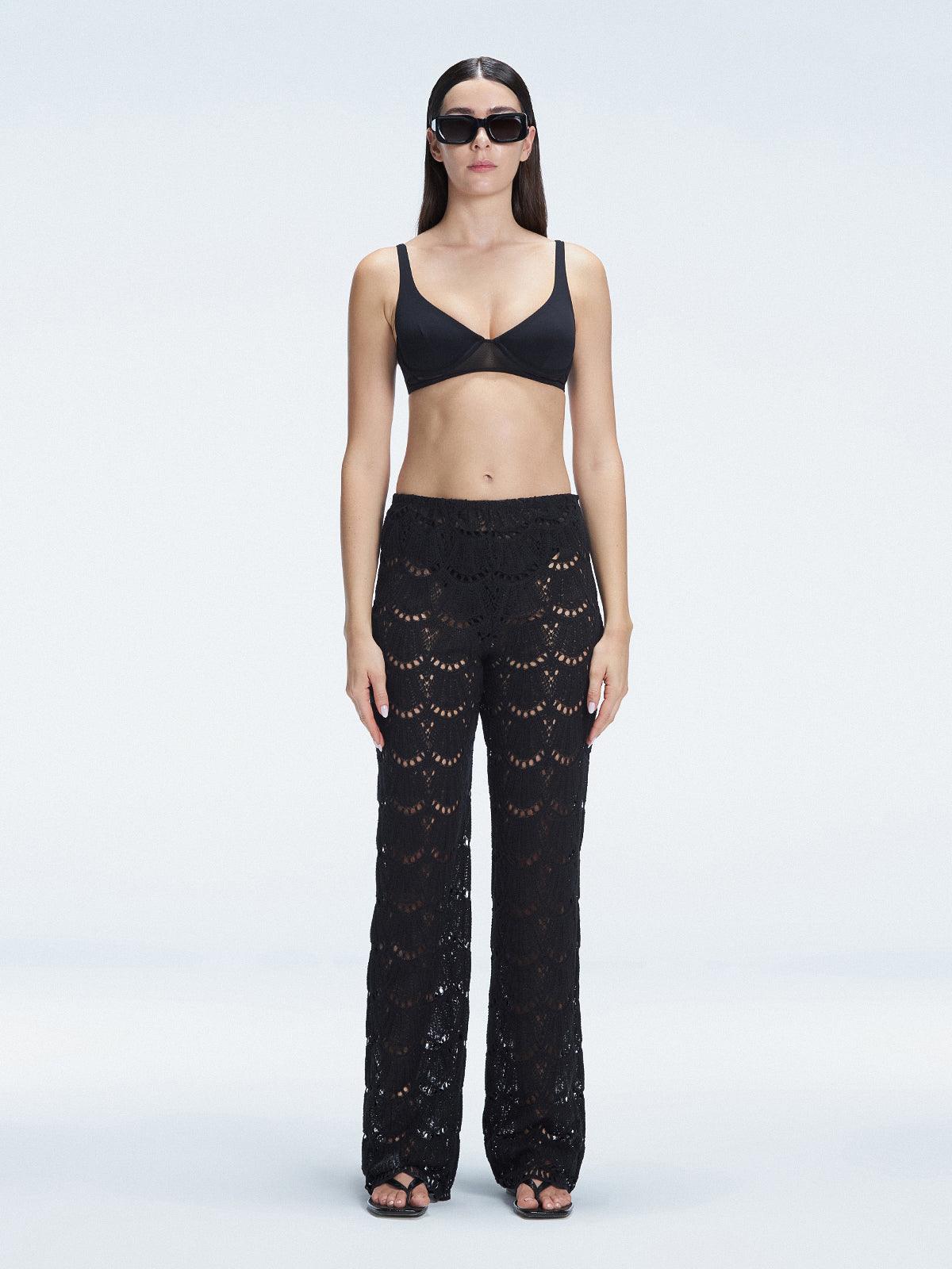 Front view of model wearing Elysia Black Wide-Leg Pants with low-rise fit and hidden side zipper.
