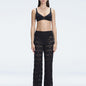 Front view of model wearing Elysia Black Wide-Leg Pants with low-rise fit and hidden side zipper.
