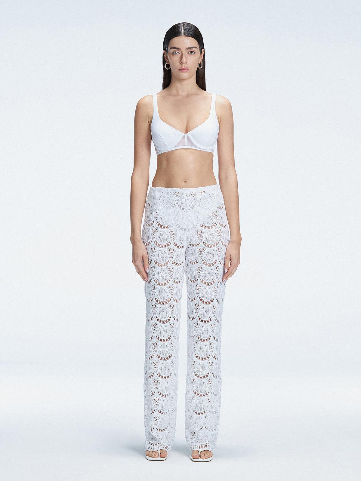 Front view of model wearing Elysia White Wide-Leg Pants with low-rise fit and hidden side zipper.
