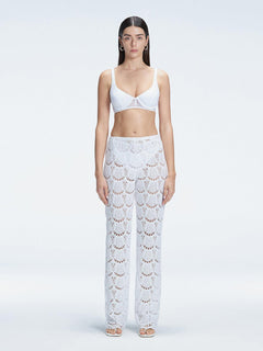 Front view of model wearing Elysia White Wide-Leg Pants with low-rise fit and hidden side zipper.
