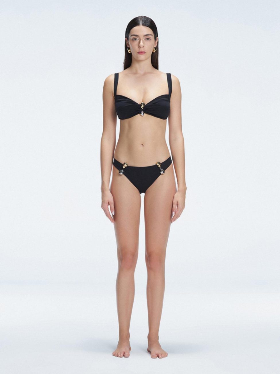 Front view of model wearing Emilia Black Bikini Top with bold buckle detail and mesh accents.
