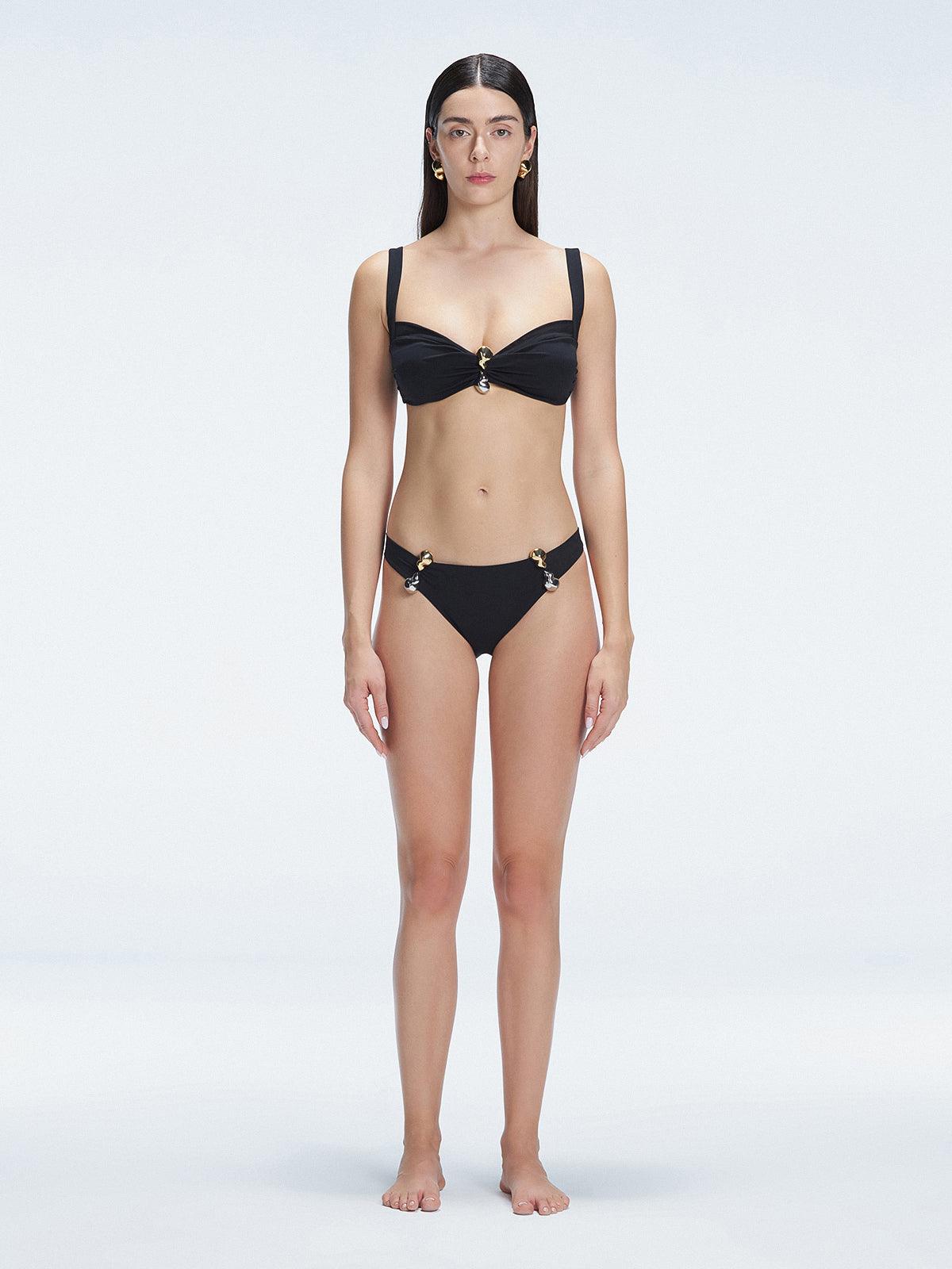 Front view of model wearing Emilia Black Bikini Top with bold buckle detail and mesh accents.
