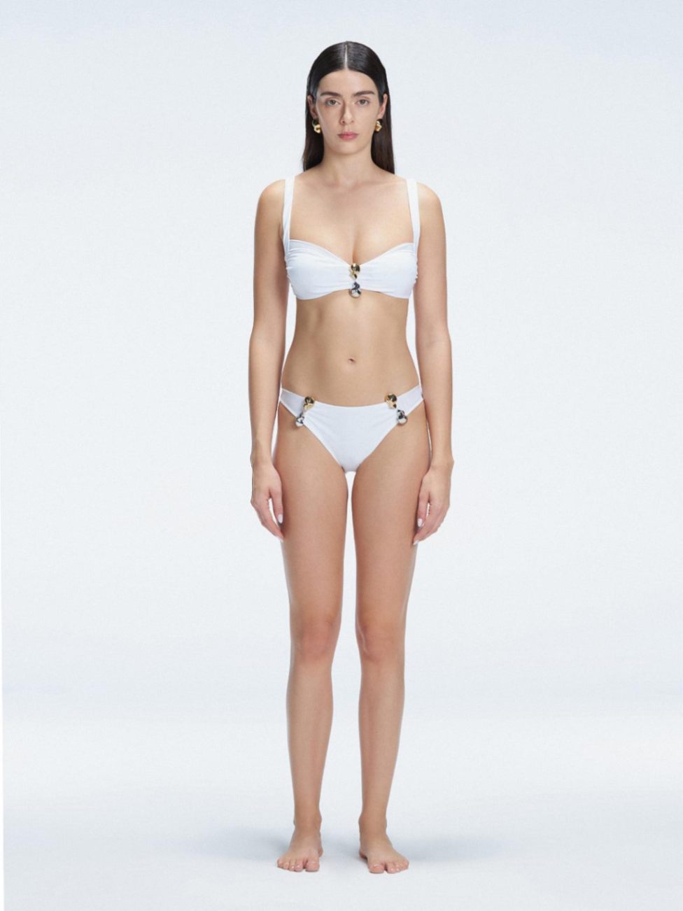 Front view of model wearing Emilia White Bikini Set  with bold buckle detail and mesh accents.
