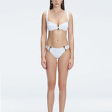 Front view of model wearing Emilia White Bikini Top with bold buckle detail and mesh accents.
