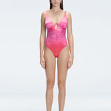 "Model wearing the Gradient Underwired Swimsuit with a ruched front and moderate bottom coverage, standing poolside."
