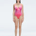 "Model wearing the Gradient Underwired Swimsuit with a ruched front and moderate bottom coverage, standing poolside."
