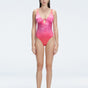 "Model wearing the Gradient Underwired Swimsuit with a ruched front and moderate bottom coverage, standing poolside."
