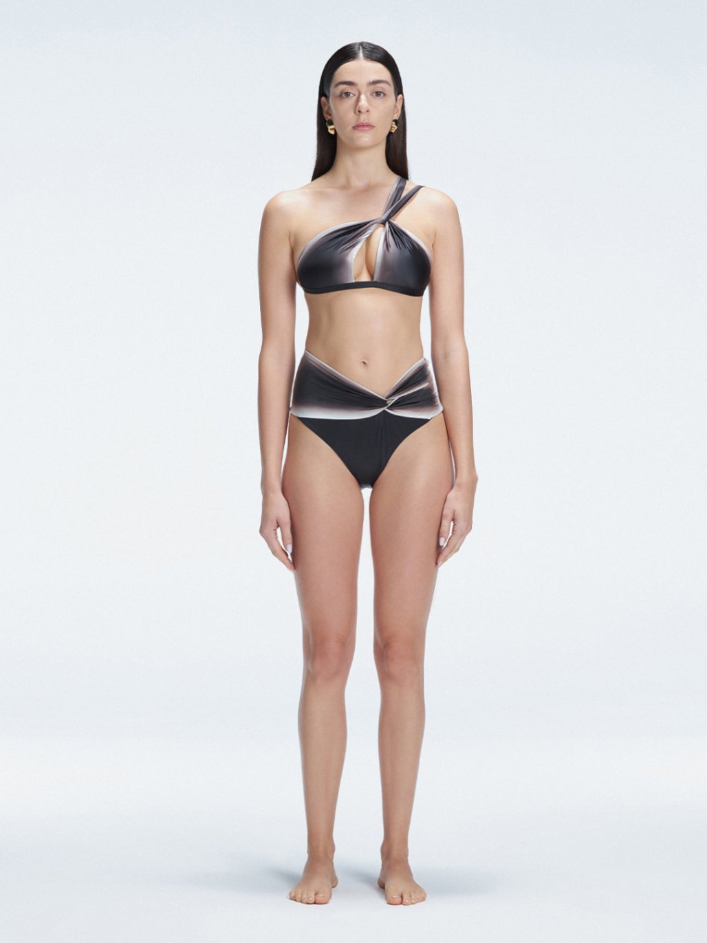 Front view of model wearing Eva Black Optical Bikini Bottom with high-waist cut and printed fabric.
