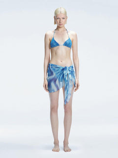 Model showcasing the Evita Blue Sonar Cover-Up with front tie, radiating elegance at the beach."