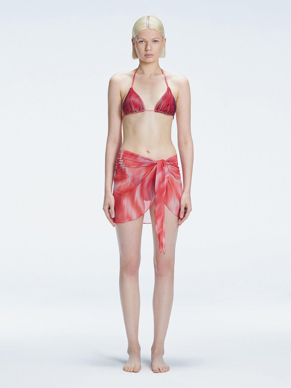 Model showcasing the Evita Red Sonar Cover-Up with front tie, radiating elegance at the beach."