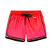 Finn Pink Degraded Swim Shorts laid flat, displaying the bold pink-red print and front tie chords for a custom fit.
