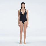 Griselda Black V-Neck Ruched Swimdress with Gold Detail | Moeva | One-Piece | Each week unveils new pieces—luxury swimwear, fluid resort silhouettes, and elevated summer-to-evening essentials designed to carry you from coastal escapes to city nights.