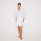 Guadalupe White Linen Shirt Dress with Tie-Front Detail | Moeva | Beachwear Dresses | Each week unveils new pieces—luxury swimwear, fluid resort silhouettes, and elevated summer-to-evening essentials designed to carry you from coastal escapes to city nights.