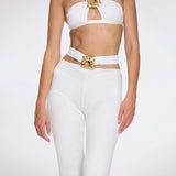 Gwyneth High-Waist with Gold Detail Satin Flare White Pants | Moeva | Women Beachwear Pants | Each week unveils new pieces—luxury swimwear, fluid resort silhouettes, and elevated summer-to-evening essentials designed to carry you from coastal escapes to city nights.