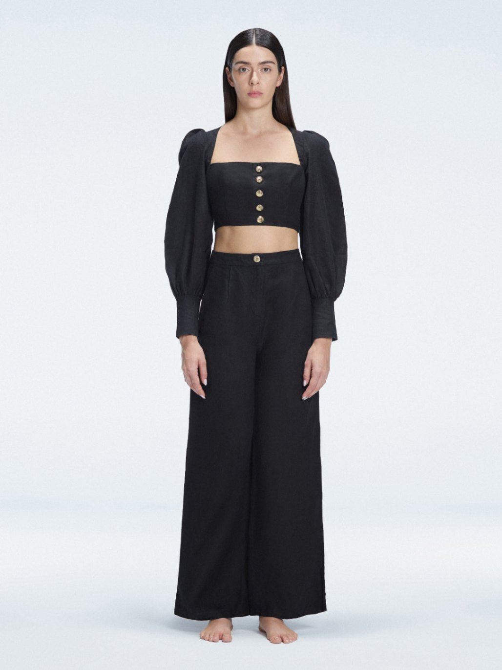 Front view of model wearing Gemma Black Cropped Top and Valencia Black Pants with blouson sleeves and sleek silhouette.
