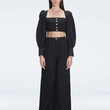 Front view of model wearing Gemma Black Cropped Top with blouson sleeves and sleek silhouette.
