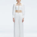 Front view of model wearing Gemma White Cropped Top with blouson sleeves and sleek silhouette.
