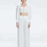 Front view of model wearing Gemma White Cropped Top with blouson sleeves and sleek silhouette.
