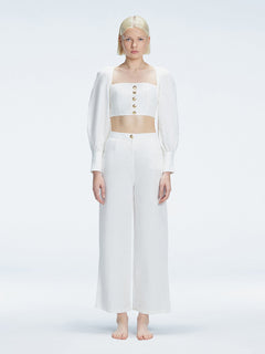 Front view of model wearing Gemma White Cropped Top with blouson sleeves and sleek silhouette.
