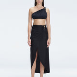 Front view of model wearing Gina Black Wrapped Skirt with flowing ankle-length design and front slip.
