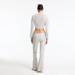 Izara Silver Mid-Rise Flared Pants | Moeva | Pants | Each week unveils new pieces—luxury swimwear, fluid resort silhouettes, and elevated summer-to-evening essentials designed to carry you from coastal escapes to city nights.