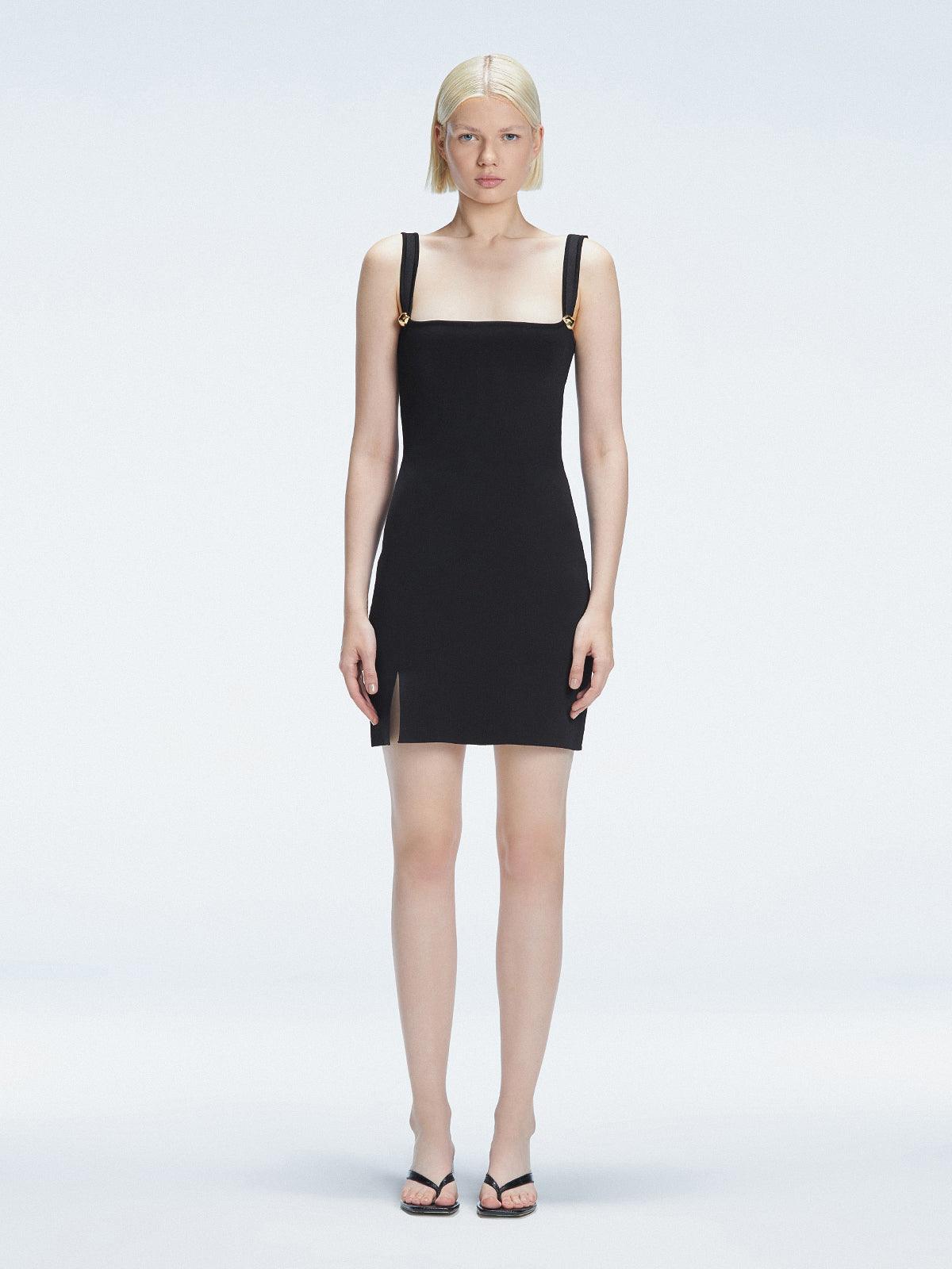 Front view of model wearing Heather Black Mini Dress with square neckline, adjustable straps, and front slit.
