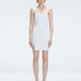 Front view of model wearing Heather White Mini Dress with square neckline, adjustable straps, and front slit.
