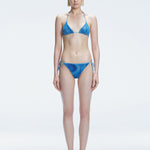 Front view of model wearing Hermione Blue Optical Bikini Bottom with low-waist cut and 3D printed design.
