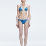 Front view of model wearing Hermione Blue Optical Bikini Bottom with low-waist cut and 3D printed design.
